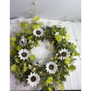 Indoor or outdoor wreath featuring white sunflowers, green leaves,‎ and berries.